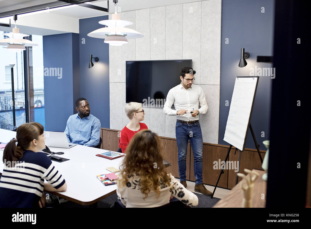 Caucasian businessman presenting to colleagues in a boardroom meeting in a contemporary office Stock Photo