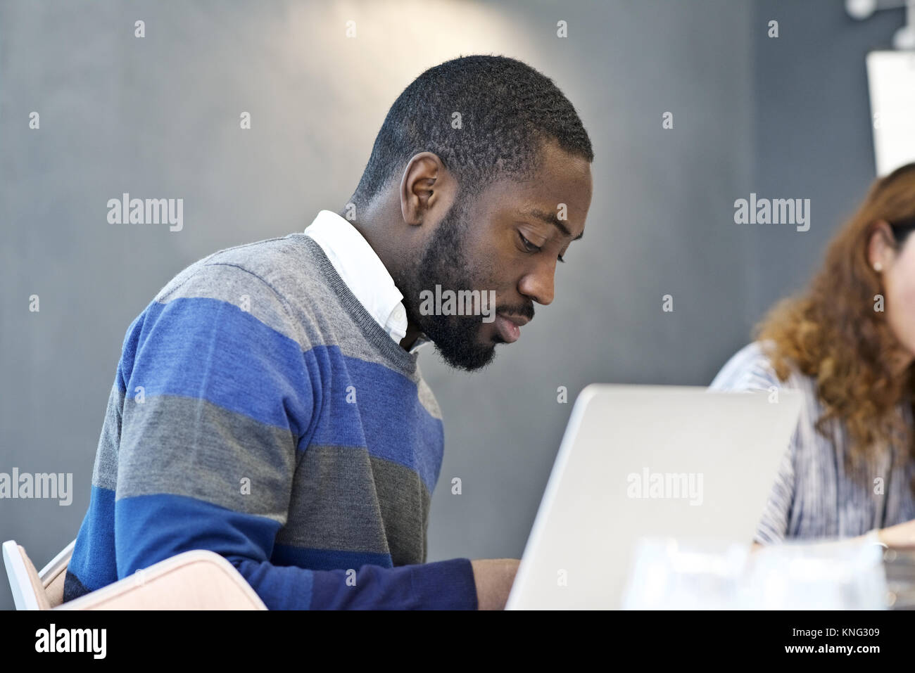 Black businessman in a business meeting with colleagues in a contemporary office boardroom Stock Photo