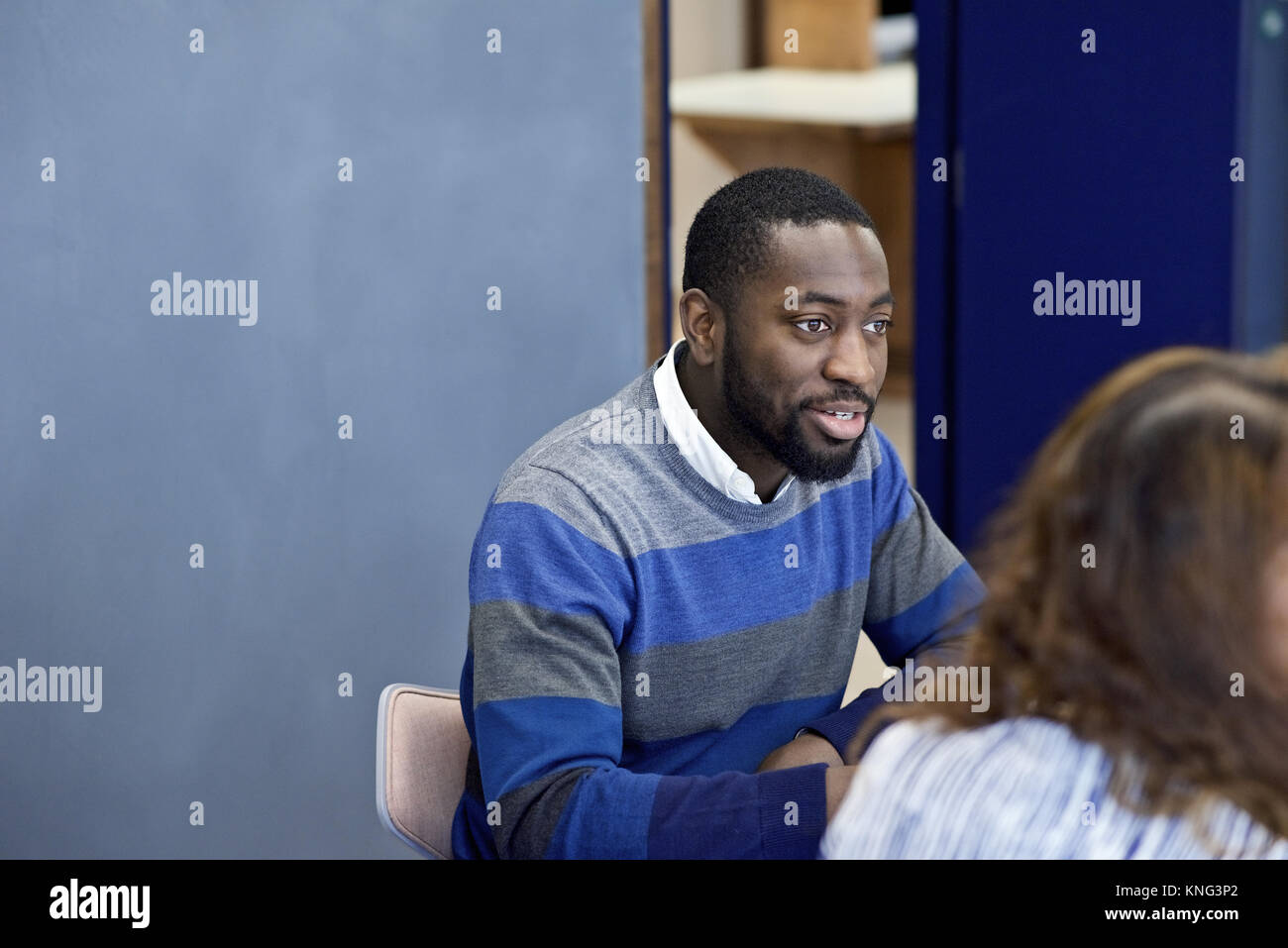 Black businessman in a business meeting with colleagues in a contemporary office boardroom Stock Photo