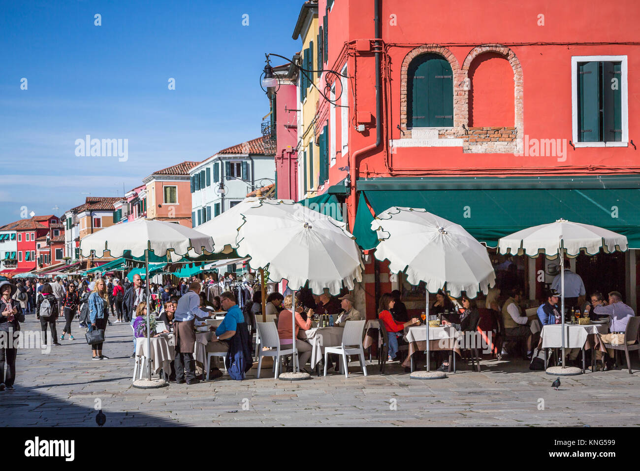People eating at an outdoor restaurant in the village of