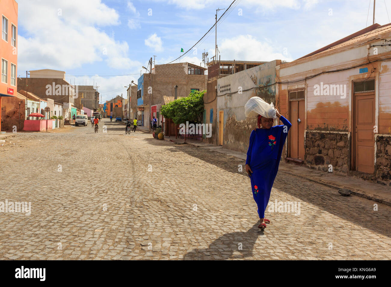 Back street details including a local woman carrying a load on her head, Santa Maria, Cape Verde, Africa Stock Photo