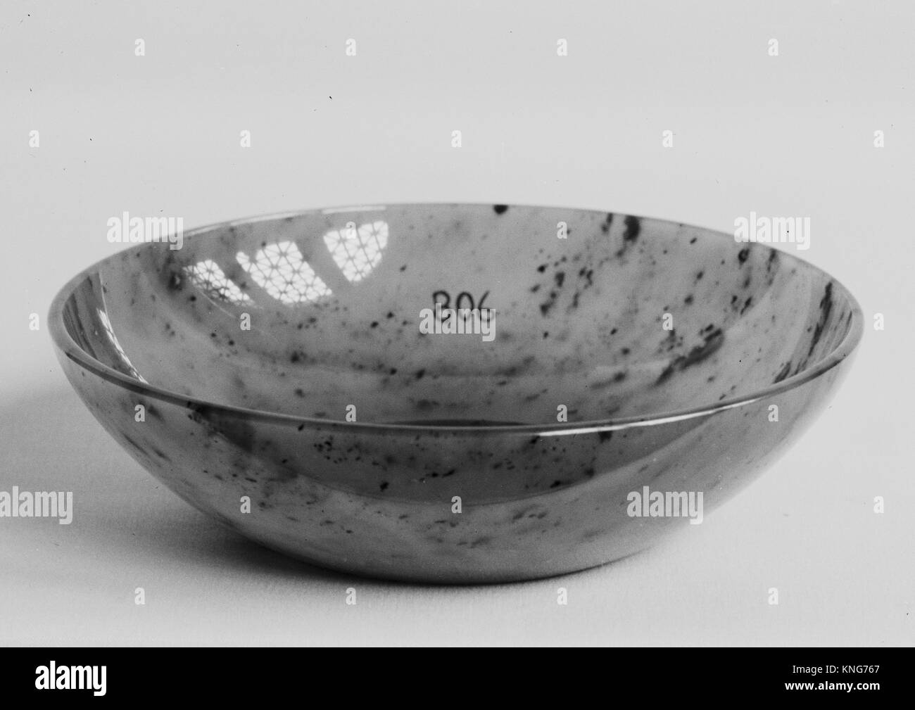 Bowl. Date: 1883; Culture: Russia; Medium: Nephrite, variegated pear-leaf green with tiny specks of black; Dimensions: H. 1 5/16 in. (3.4 cm); W. 4 Stock Photo
