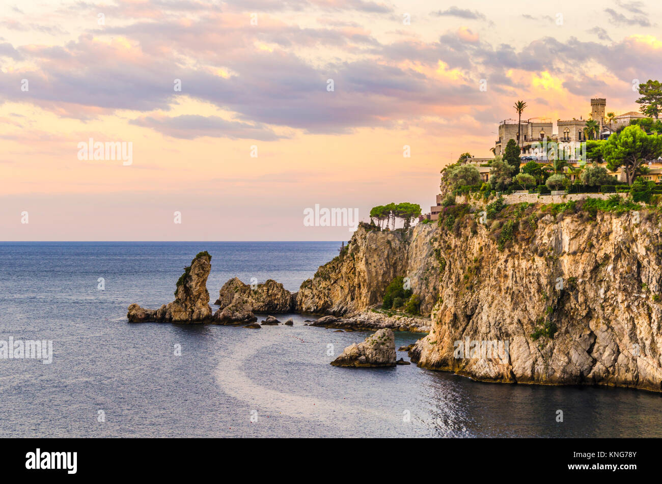 Sunset landscape on the sicilian coast farallones at the height of the town of tahormina italy Stock Photo