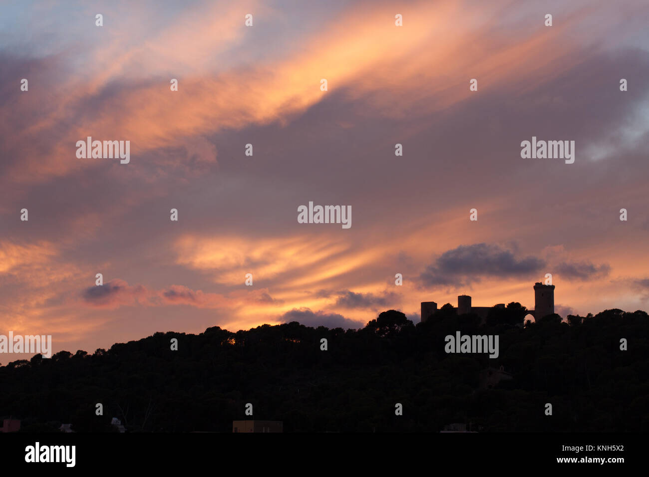 Silhouette of Bellver castle against dramatic sunset sky. Palma, Majorca, Spain Stock Photo