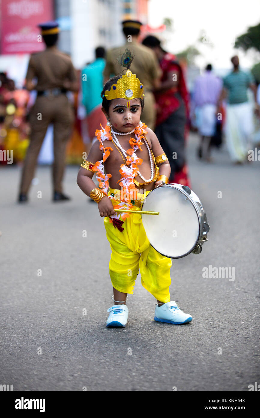 funny kid dressed up like krishna colourfulful attire during maha