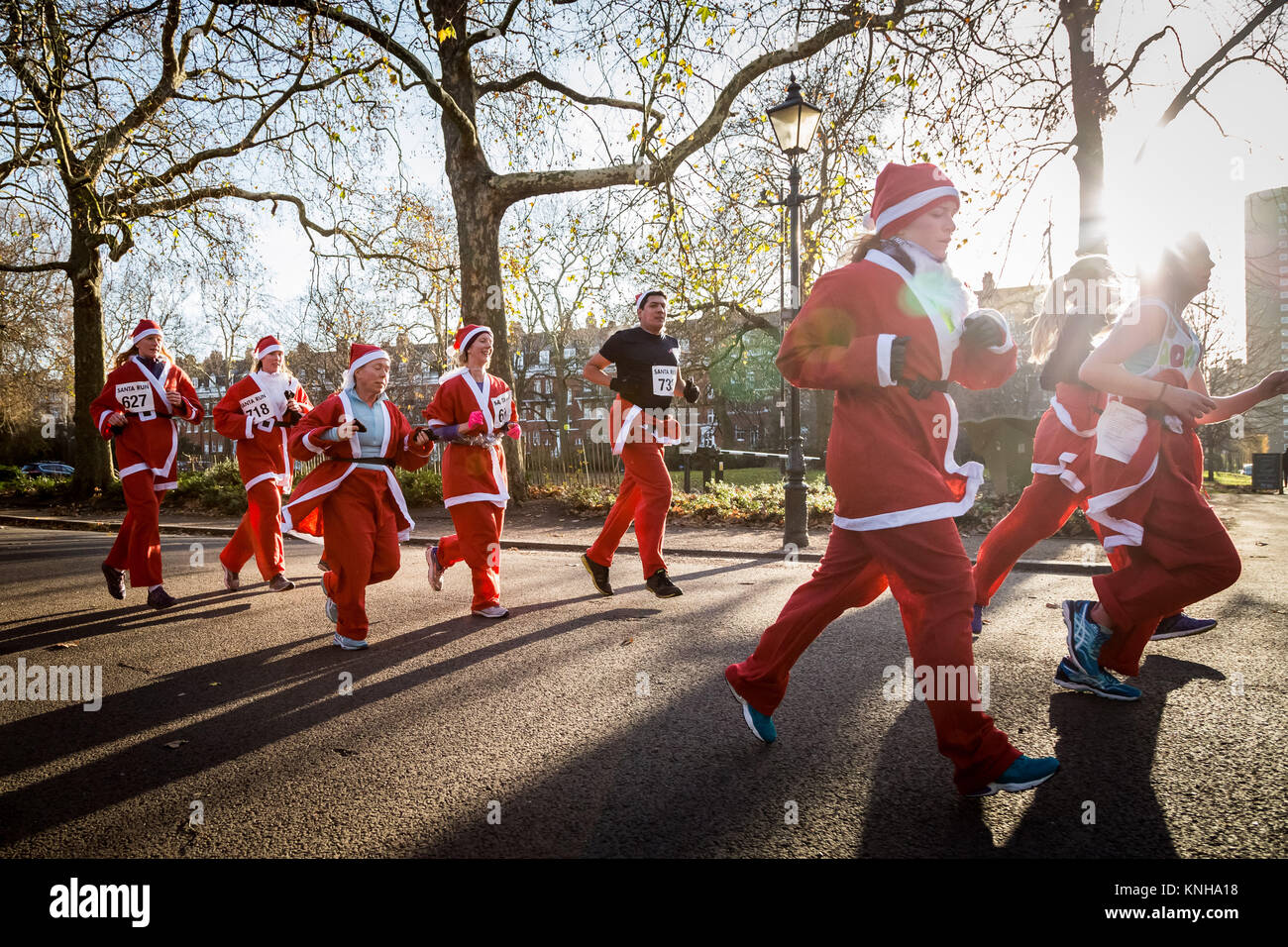 London, UK. 9th Dec, 2017. Hundreds of Santas attend the annual 5km Santa Run in Battersea park. Credit: Guy Corbishley/Alamy Live News Stock Photo