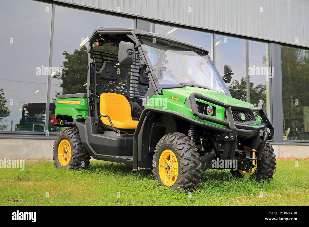 SALO, FINLAND - AUGUST 9, 2014: John Deere Gator XUV550 Crossover Utility Vehicle on grass. The Gator has a V-twin engine and independent four-wheel s Stock Photo