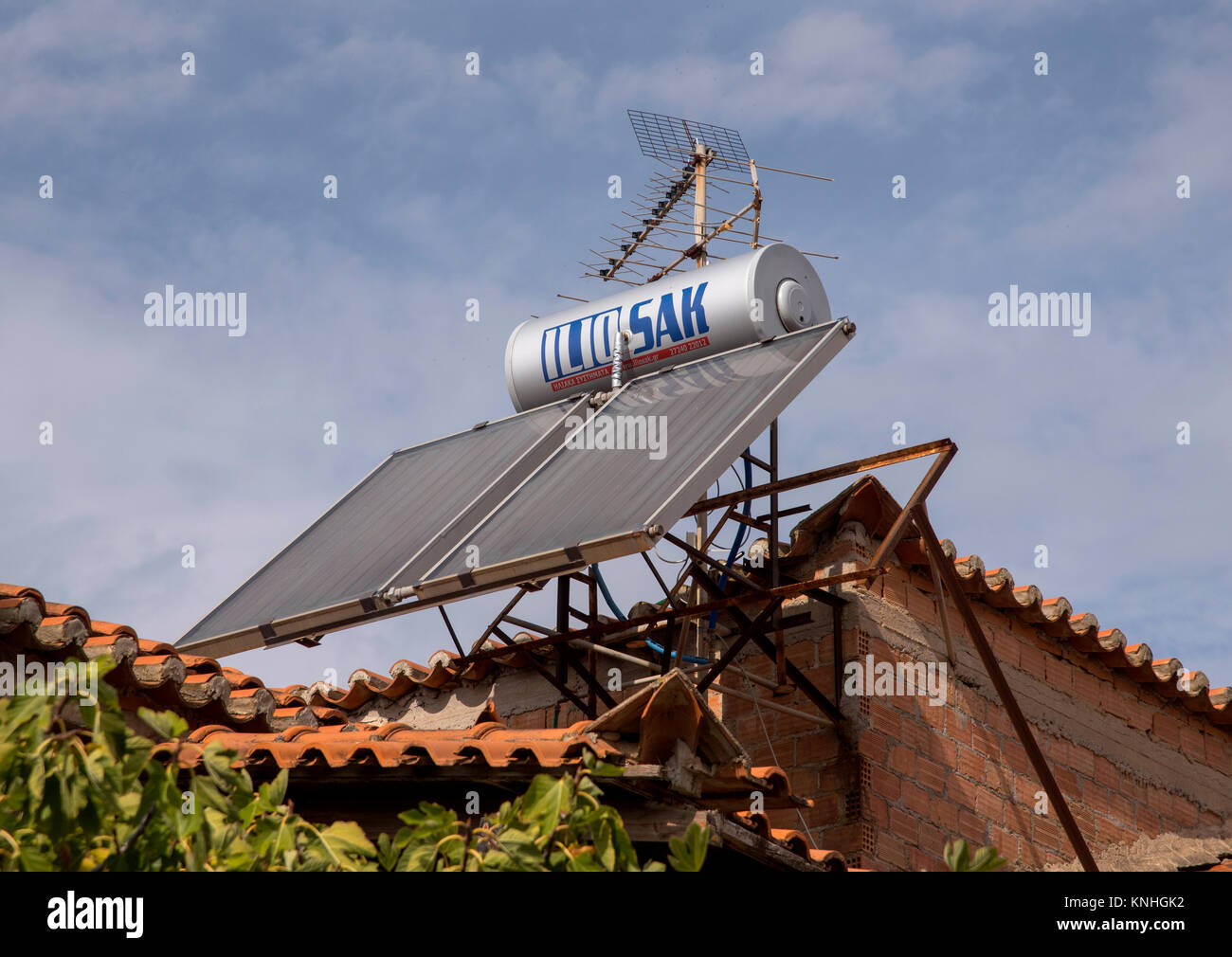 Solar hot water tank on a roof top in rural Greece, now seen on almost all homes Stock Photo