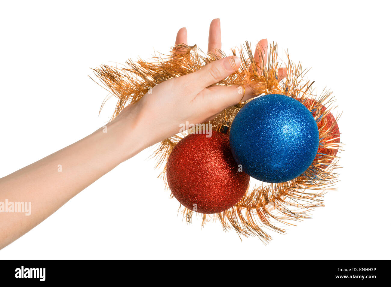 Woman hand holding or given Christmas decorations. Isolated on white Stock Photo