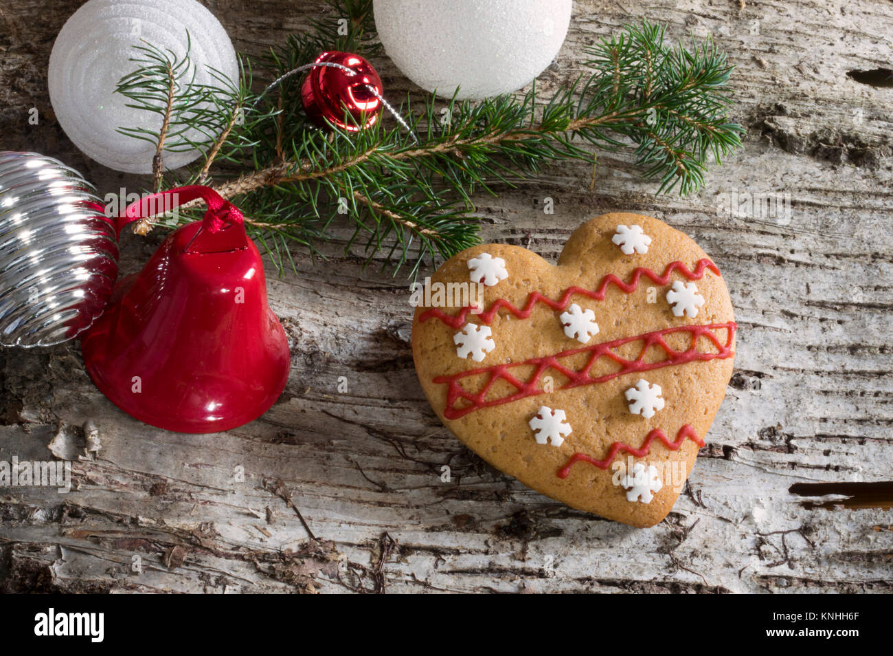 Wood bark background with christmas decoration, pine branch and gingerbread cookies Stock Photo
