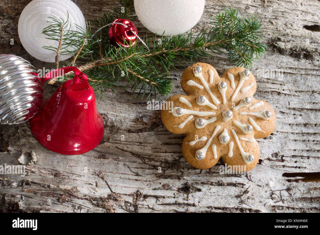 Wood bark background with christmas decoration, pine branch and gingerbread cookies Stock Photo