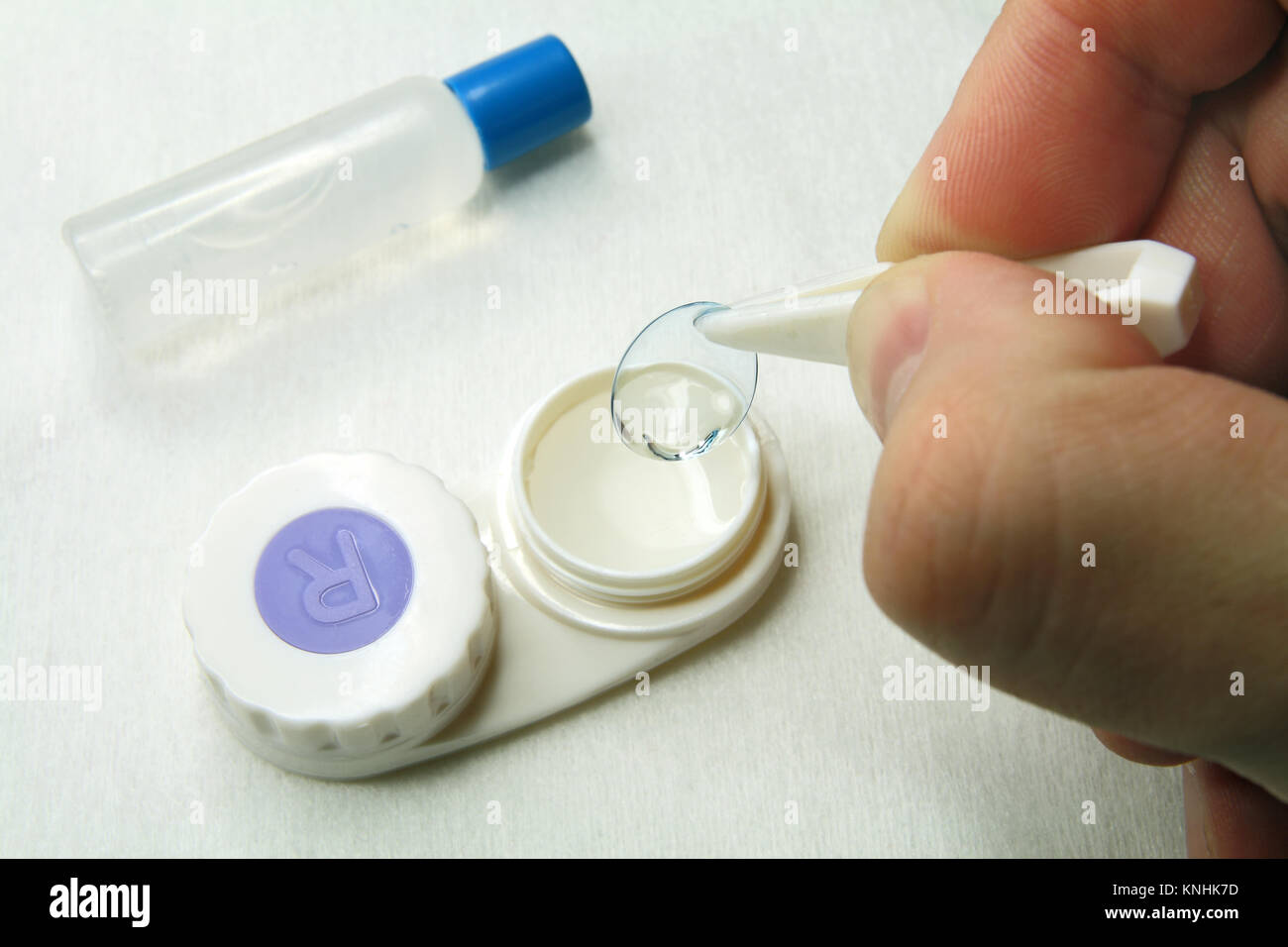 Removing the contact lenses out of the case Stock Photo Alamy
