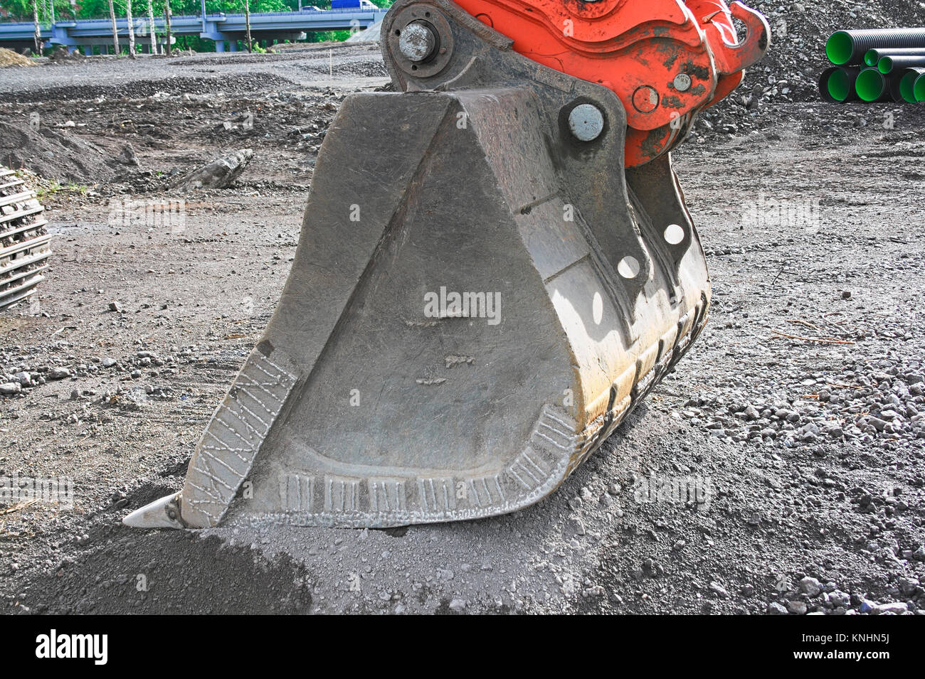 excavator on construction site, in the background the blue sky and sun ...