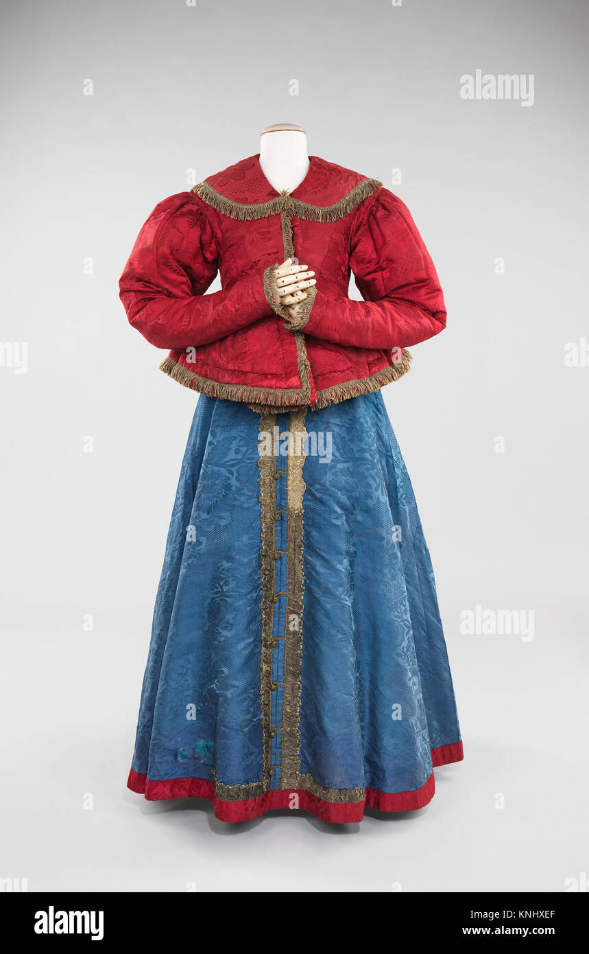 This dress, from a specific period in fashion history, displays the ...
