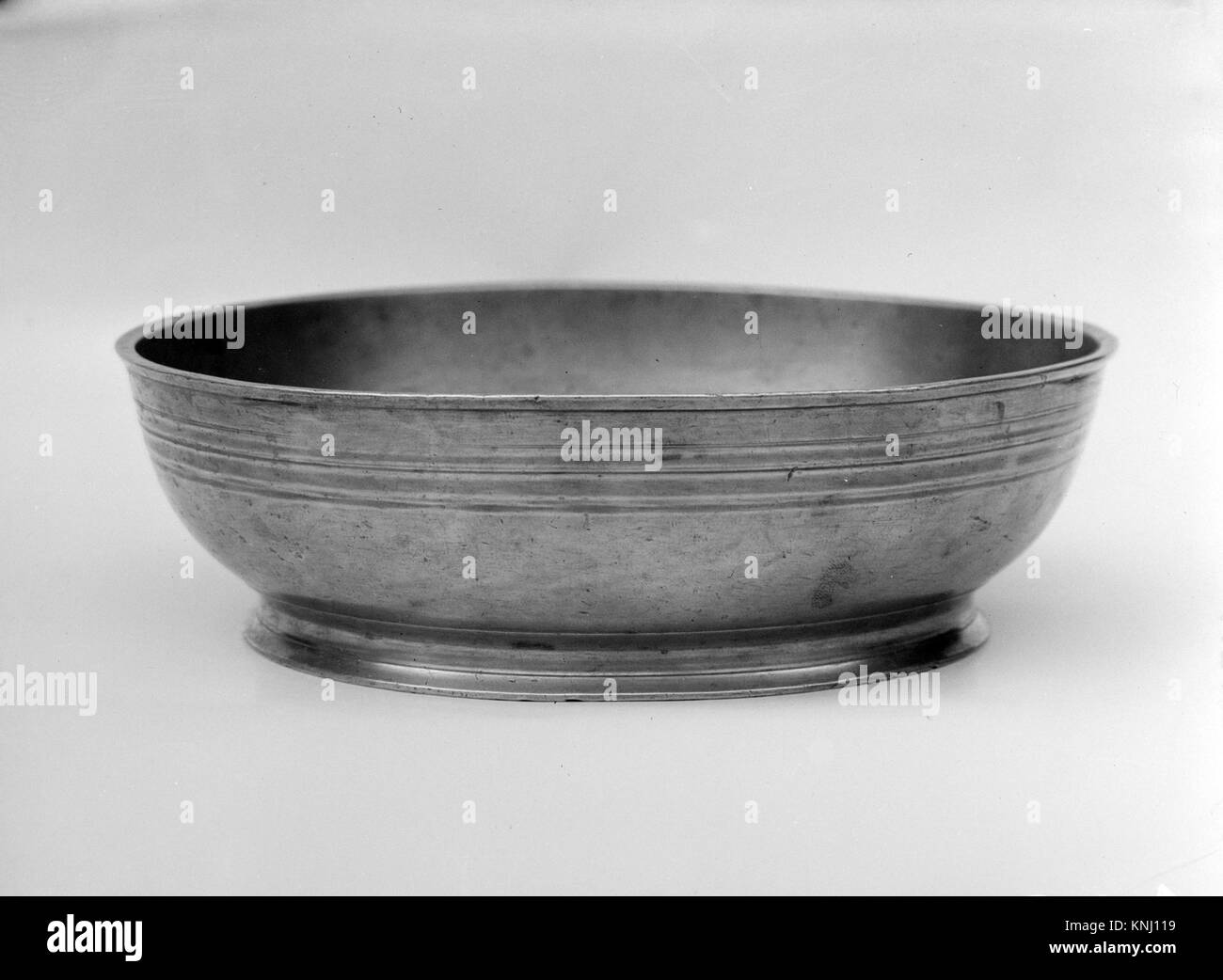 Baptismal Bowl MET 141403 322 Maker: Samuel Danforth, 1774?1816, Baptismal Bowl, 1795?1816, Pewter, H. 2 1/4 in. (5.7 cm); Diam. 7 5/8 in. (19.4 cm). The Metropolitan Museum of Art, New York. Gift of Mrs. J. Insley Blair, in memory of her husband, 1941 (48.91) Stock Photo