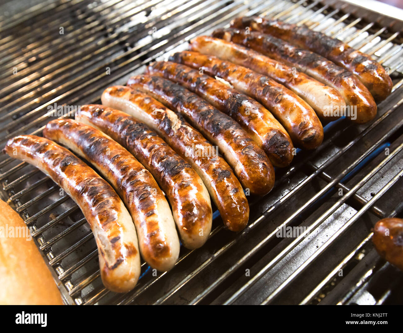 Bratwurst sausages being grilled on an outdoor BBQ grill Stock Photo - Alamy