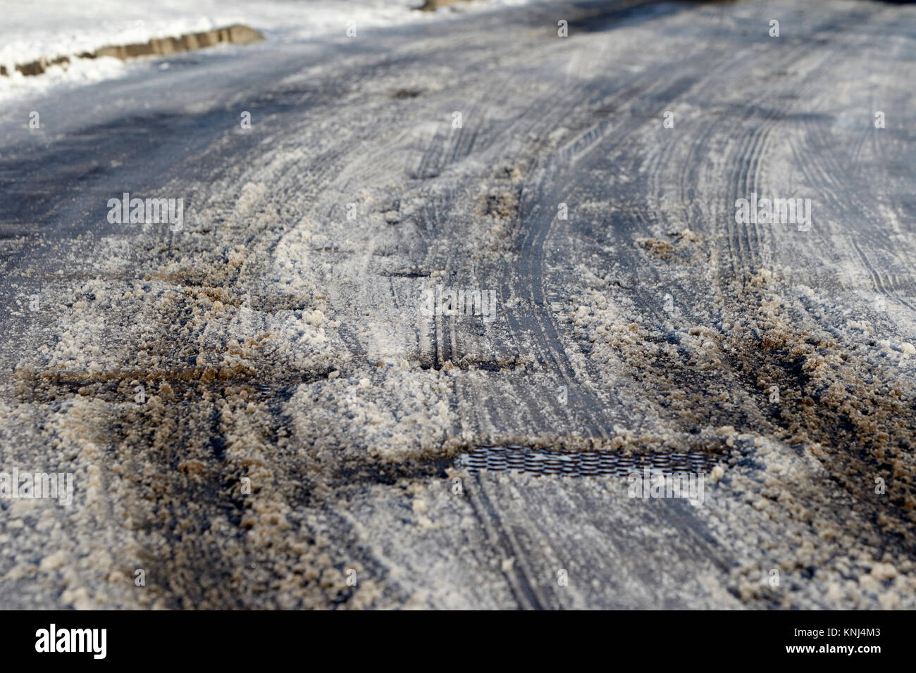tyre tracks in snow showing black ice underneath newtownabbey northern ireland uk Stock Photo