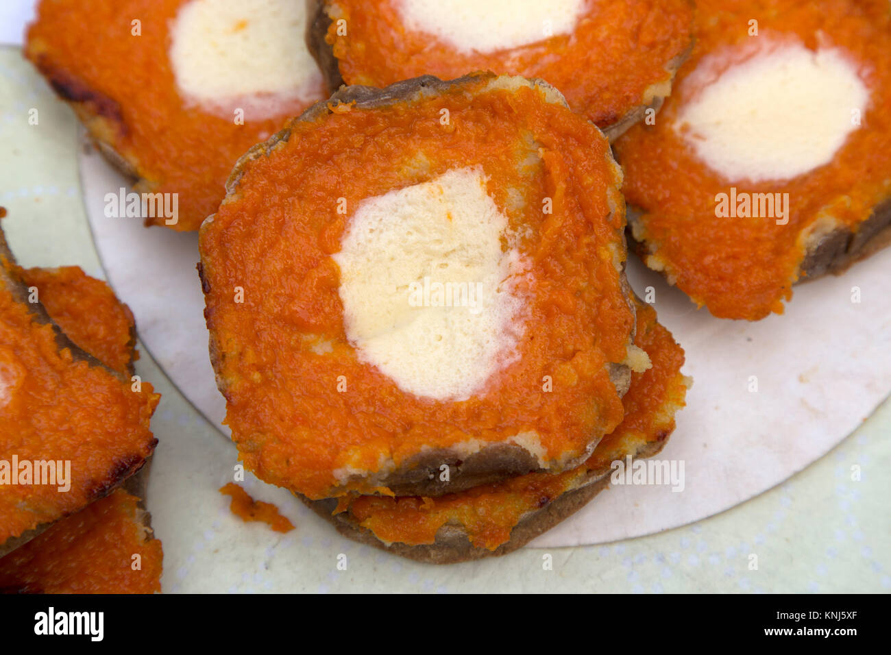 Orange cakes on sale at a Christmas market in Riga, Latvia. The cakes have a dollop of cream in them. Stock Photo