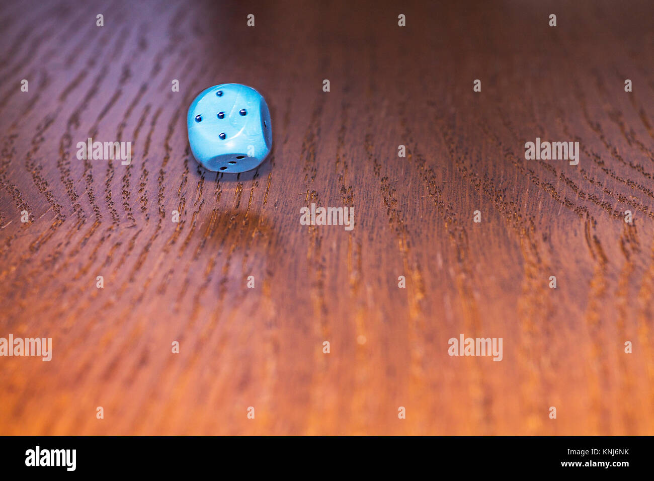 The dice roll on the wooden table. Role-playing game Dungeons and Dragons. Gambling in the casino. Stock Photo