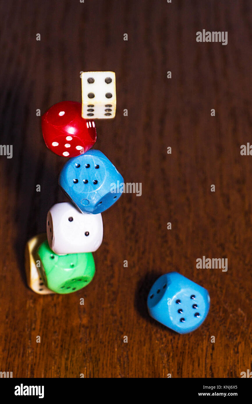 The dice roll on the wooden table. Role-playing game Dungeons and Dragons. Gambling in the casino. Stock Photo