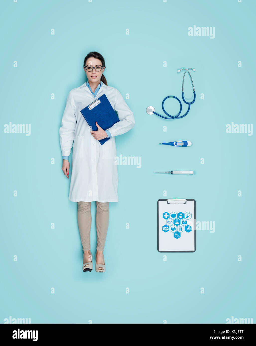 Lifelike smiling female doctor human doll wearing a lab coat and medical equipment accessories Stock Photo