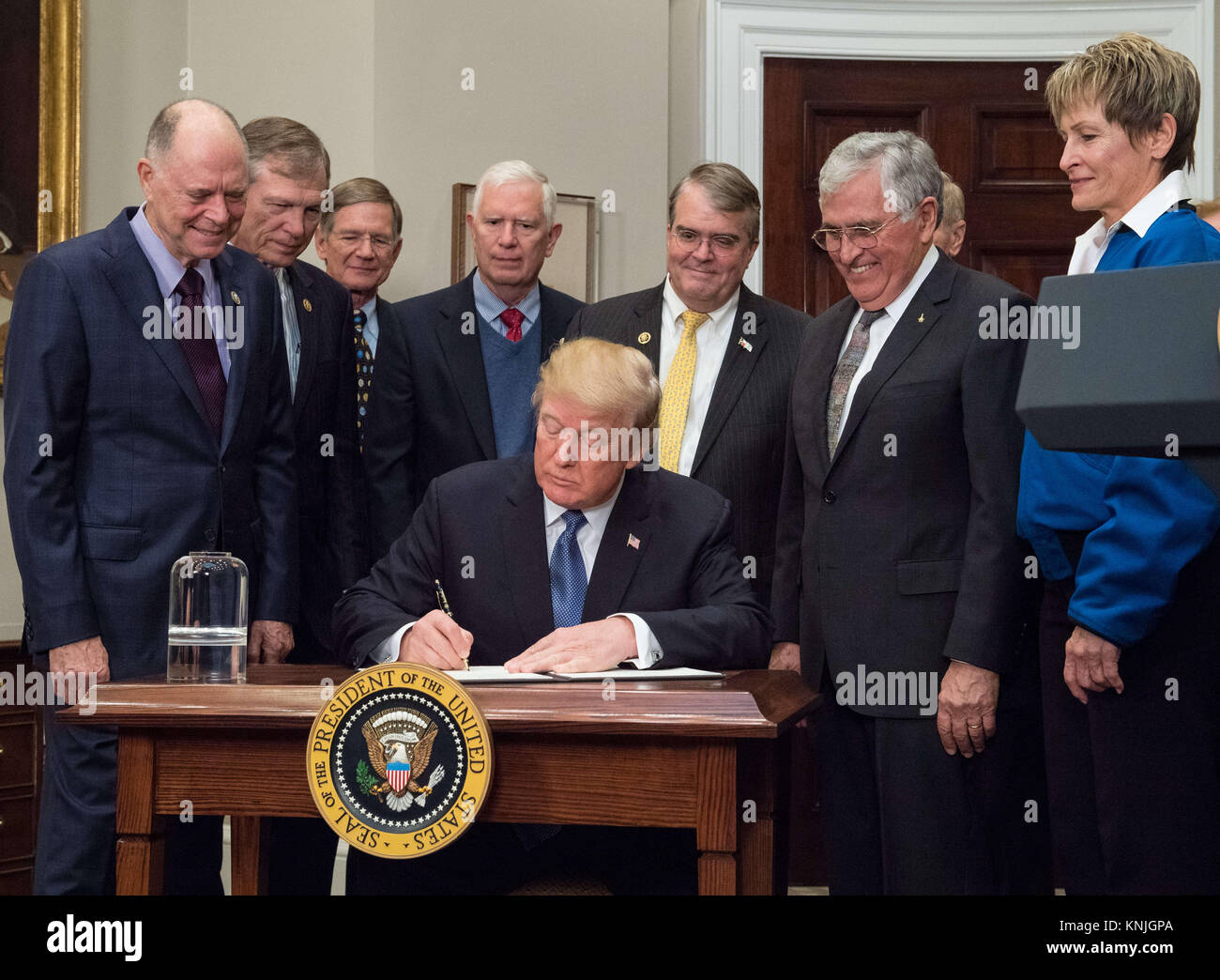 United States President Donald J. Trump signs the Presidential Space Directive. 11th Dec, 2017. 1, directing NASA to return to the moon, alongside members of the Senate, Congress, NASA, and commercial space companies in the Roosevelt room of the White House in Washington, Monday, December 11, 2017. Mandatory Credit: Aubrey Gemignani/NASA via CNP Credit: Aubrey Gemignani/CNP/ZUMA Wire/Alamy Live News Stock Photo