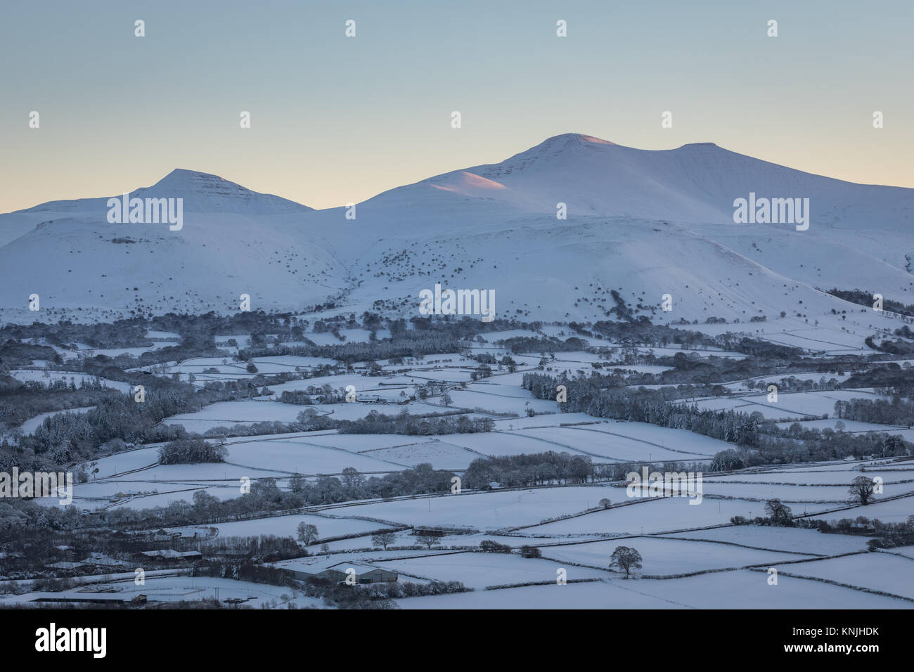 Paxton's Tower. UK. 11th December, 2017. Looking across a snow covered landsape at sunset, towards Pen y Fan mountain from Pen y Crug hill fort. Brecon Beacons National Park, Wales. Credit: Drew Buckley/Alamy Live News Stock Photo