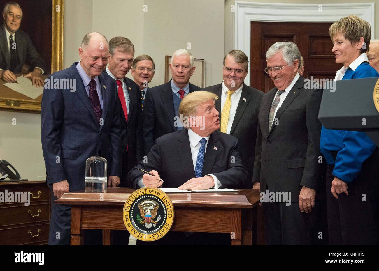 United States President Donald J. Trump prepares to sign the Presidential Space Directive. 11th Dec, 2017. 1, directing NASA to return to the moon, alongside members of the Senate, Congress, NASA, and commercial space companies in the Roosevelt Room of the White House in Washington, Monday, December 11, 2017. Mandatory Credit: Aubrey Gemignani/NASA via CNP Credit: Aubrey Gemignani/CNP/ZUMA Wire/Alamy Live News Stock Photo