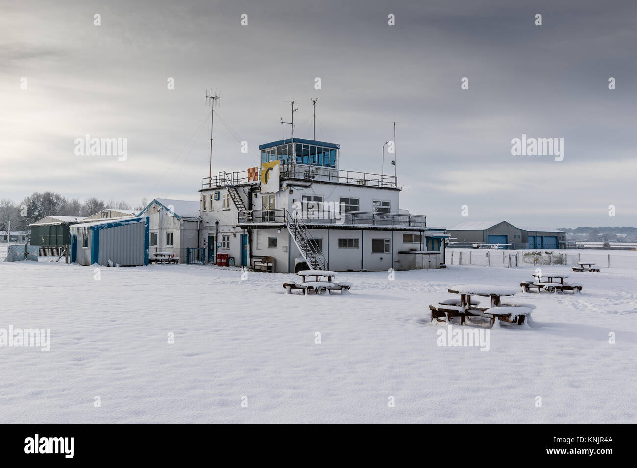 Wolverhampton Halfpenny Green Airport, Bobbington, UK. 12th Dec, 2017. On the coldest night of the year so far, with overnight temperatures dropping to minus 10c in parts of Staffordshire and Shropshire, freezing temperatures and snow continue to add disruption. Wolverhampton Halfpenny Green Airport that lies on the boundary of the two counties remained closed blanketed with 5 inches of snow and ice. Although many aircraft were wrapped up against the weather a few tipped on to their tales under the weight of the snow and ice. Credit: Paul Bunch/Alamy Live News Stock Photo