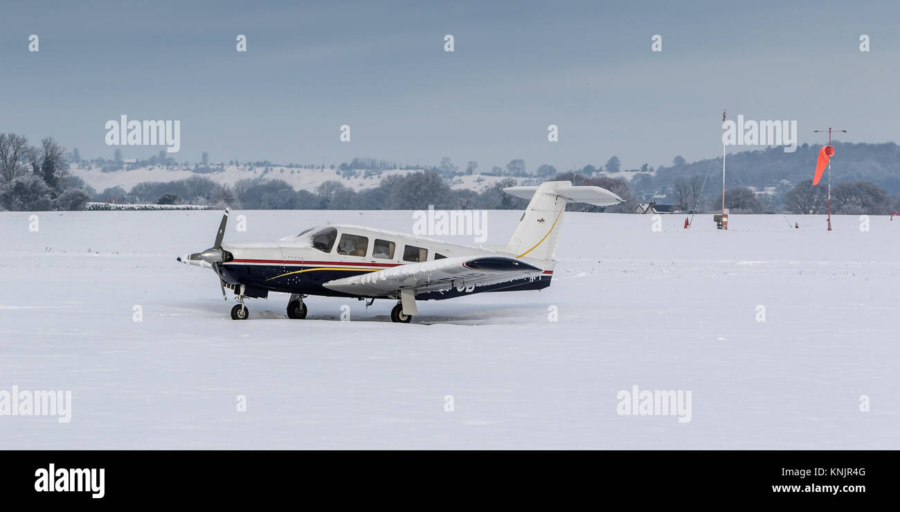 Wolverhampton Halfpenny Green Airport, Bobbington, UK. 12th Dec, 2017. On the coldest night of the year so far, with overnight temperatures dropping to minus 10c in parts of Staffordshire and Shropshire, freezing temperatures and snow continue to add disruption. Wolverhampton Halfpenny Green Airport that lies on the boundary of the two counties remained closed blanketed with 5 inches of snow and ice. Although many aircraft were wrapped up against the weather a few tipped on to their tales under the weight of the snow and ice. Credit: Paul Bunch/Alamy Live News Stock Photo