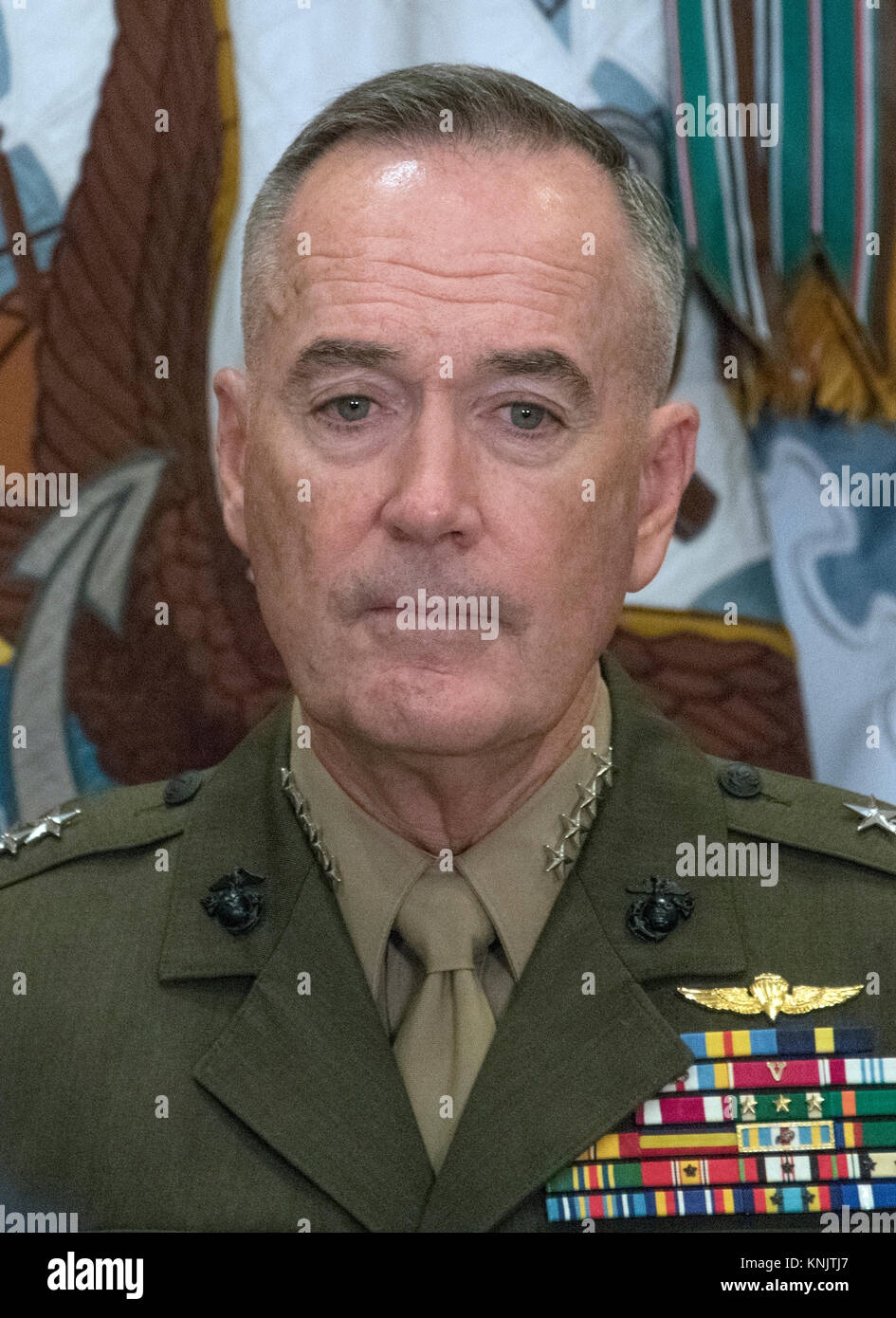 United States Marine Corps General Joseph F. Dunford Jr., Chairman, Joint Chiefs of Staff, looks on as US President Donald J. Trump makes remarks prior to signing H.R. 2810, National Defense Authorization Act for Fiscal Year 2018, in the Roosevelt Room of the White House in Washington, DC on Tuesday, December 12, 2017. Credit: Ron Sachs/CNP /MediaPunch Stock Photo