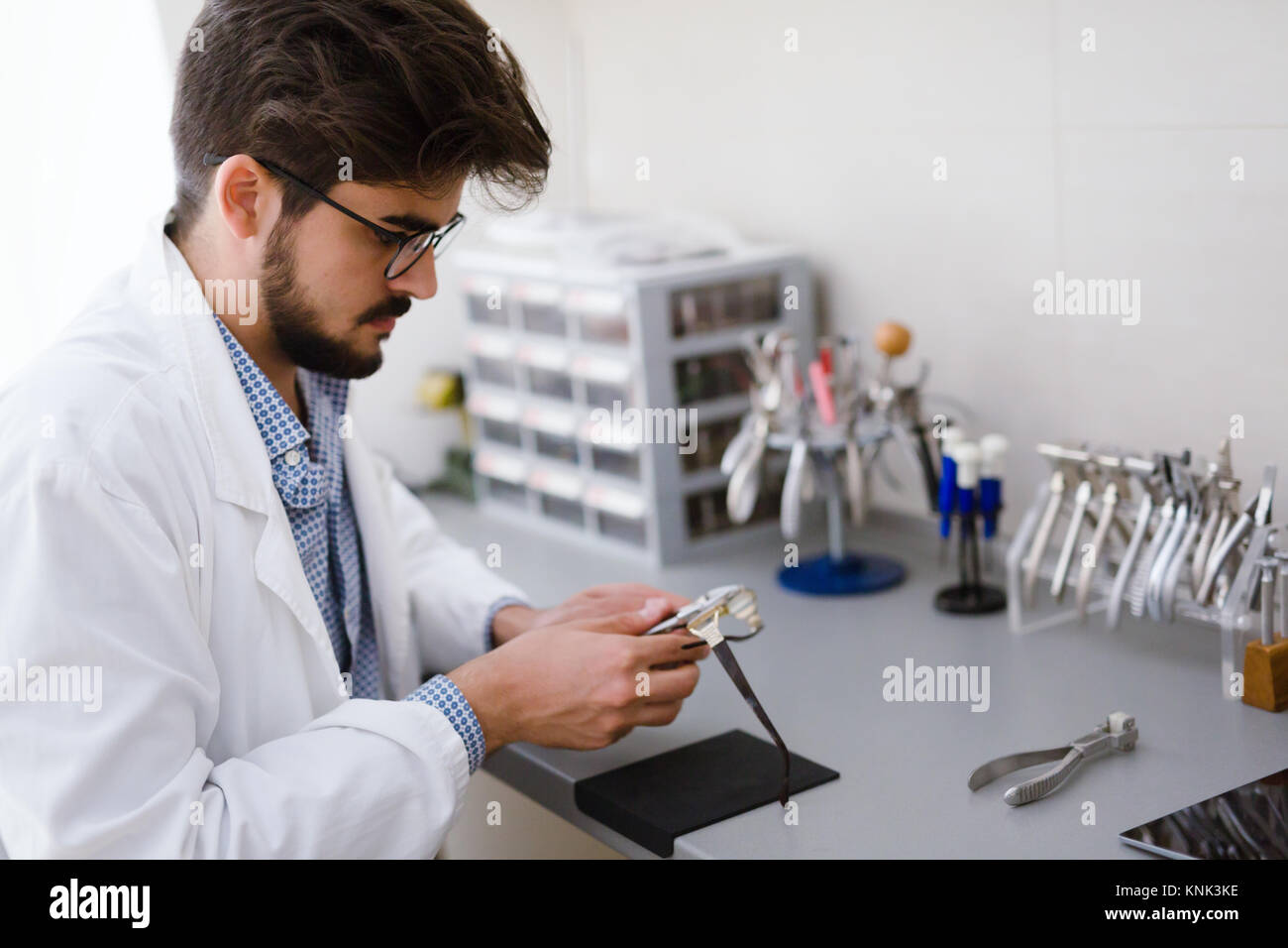 Optician repairing and fixing eye glasses Stock Photo