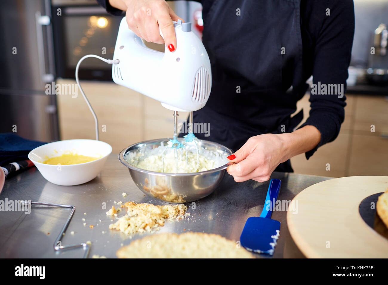 The confectioner makes a blender a cream for a cake in the kitch Stock Photo Alamy