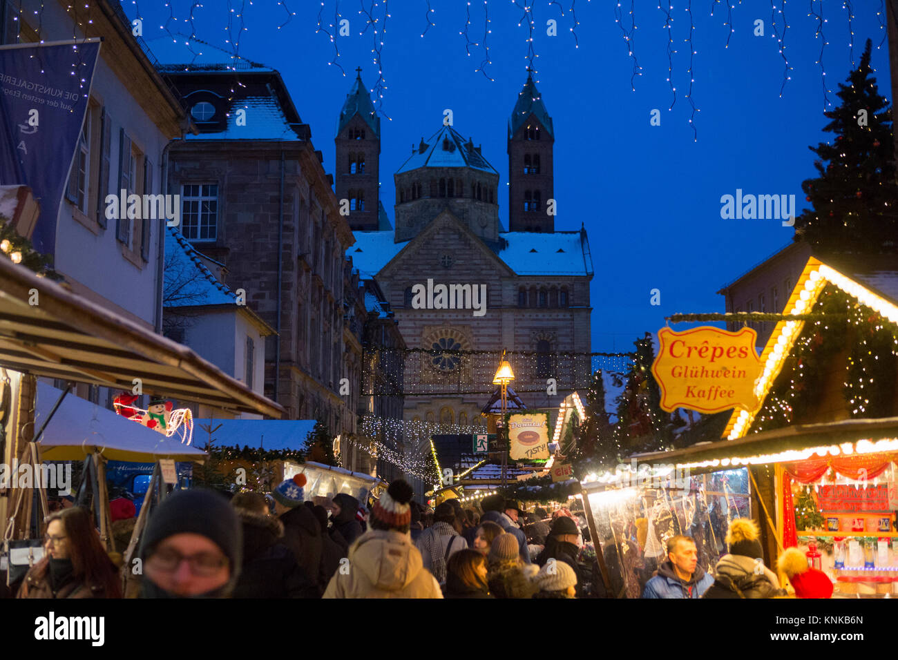 People stroll through the Christmas market. The Speyer Cathedral can be