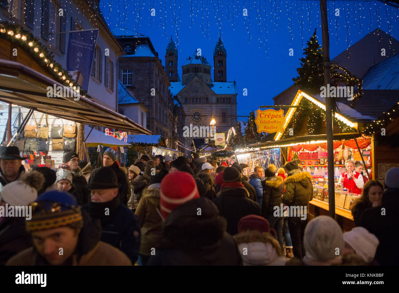 People stroll through the Christmas market. The Speyer Cathedral can be