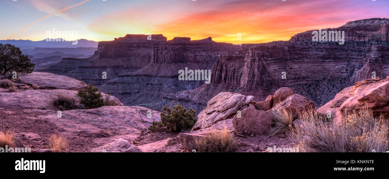 Colorful sunrise over Shafer Canyon, off the Shaefer Trail in Canyonlands National Park, Utah. Stock Photo