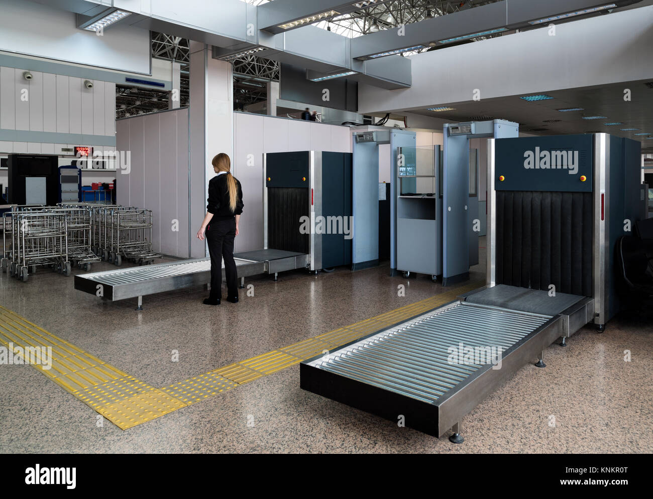 Control baggage at the airport. Security officer at the airport works at scanner Stock Photo