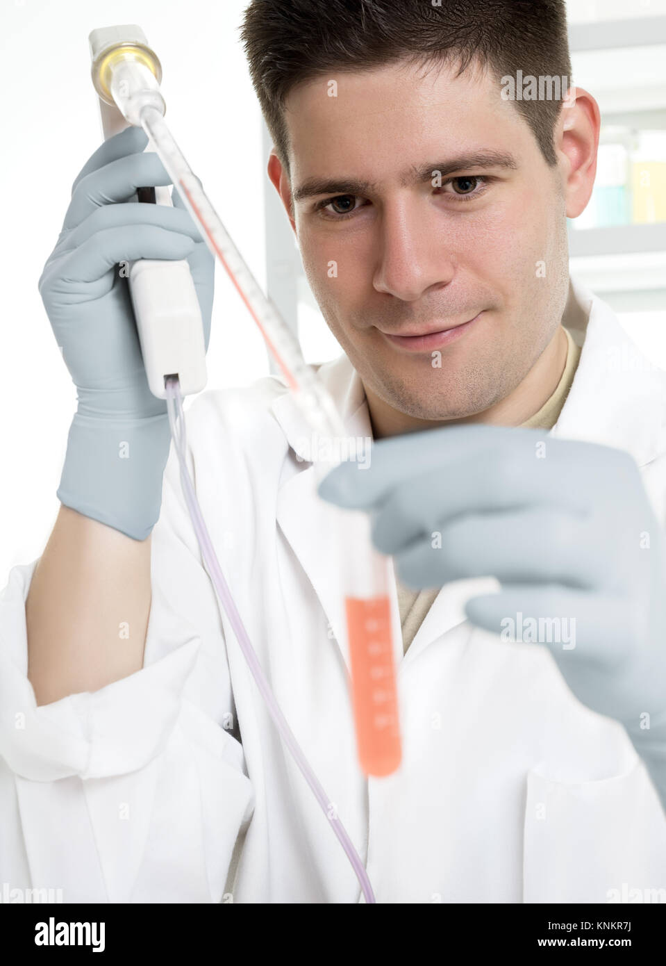 Young energetic scientist loads sample in a tube Stock Photo