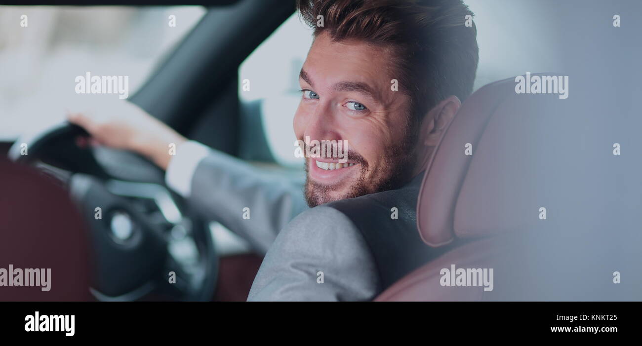 Portrait of an handsome smiling business man driving his car Stock ...