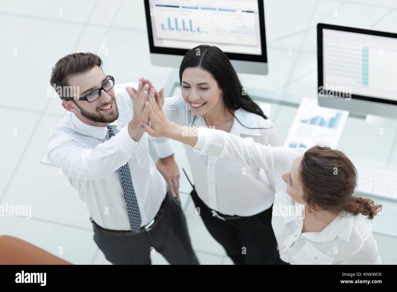 successful business team giving each other a high five Stock Photo - Alamy