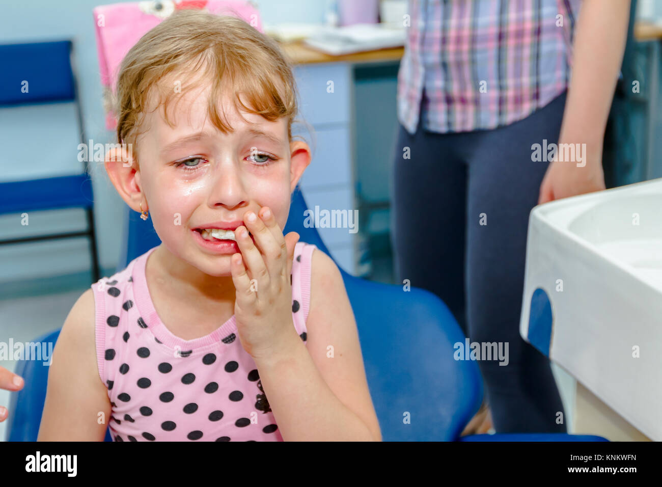 Frightened sweet little girl is at dentist after extraction of milk ...