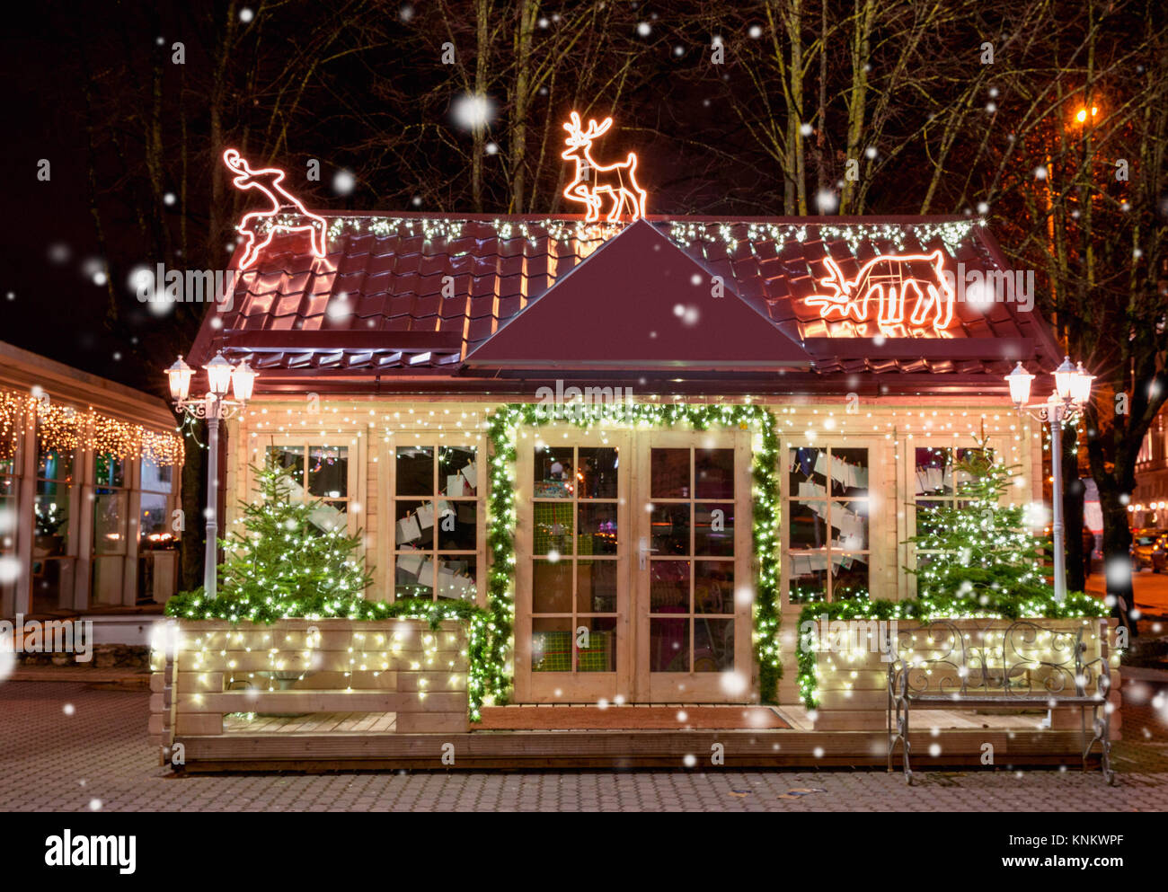 Wooden small house with New Year decoration in the night. Christmas  background. Christmas window. Christmas tree outside the window Stock Photo  - Alamy