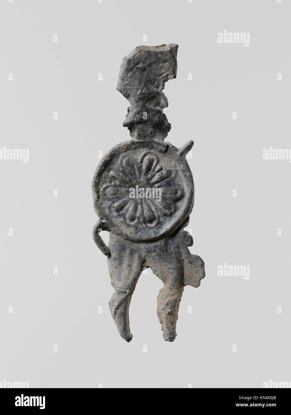 Lead figure of a warrior with a helmet, shield, and spear. Period