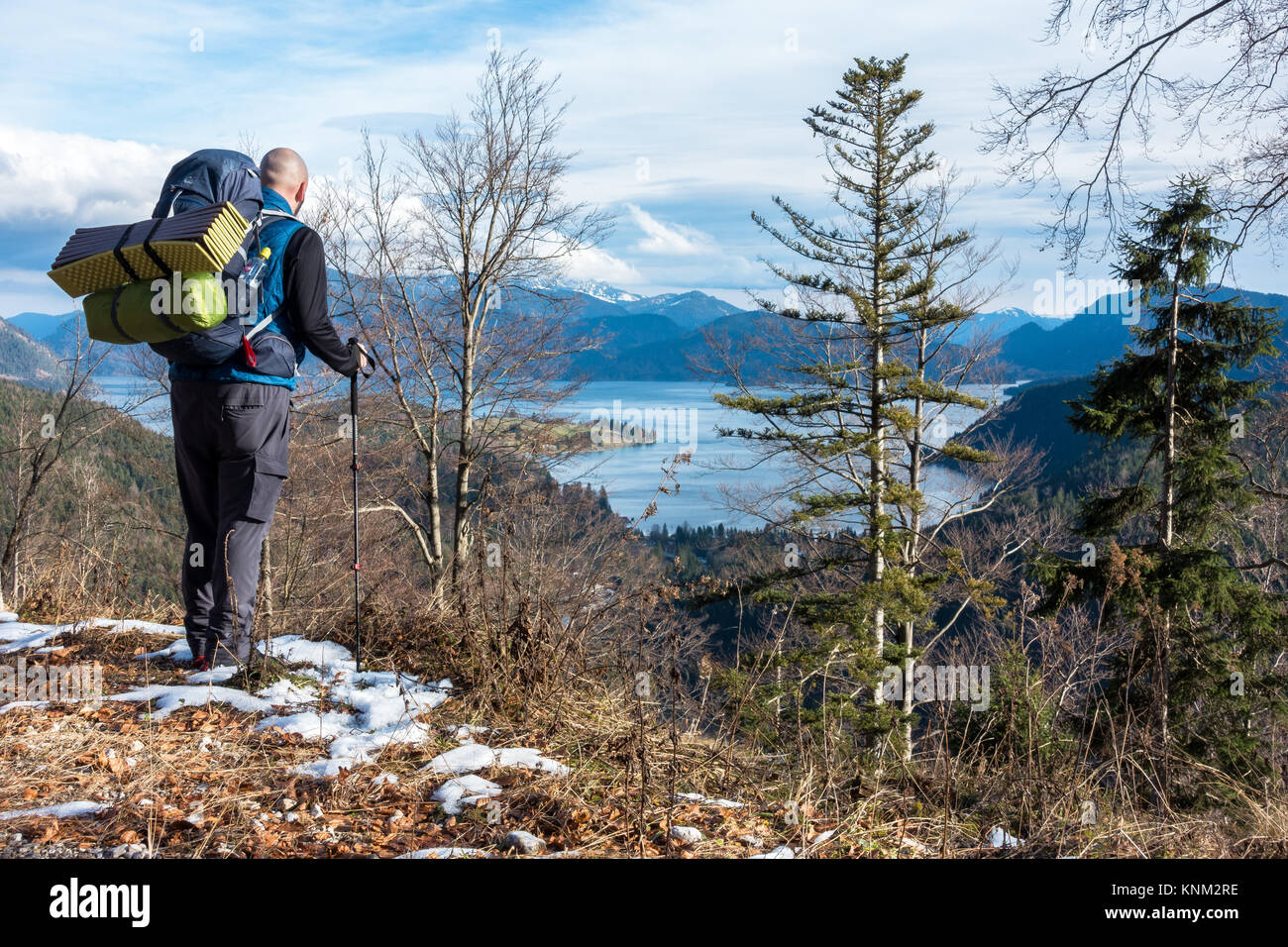 Hiker enjoying the view over lake Walchensee in the Bavarian Pre-Alps in a winter day Stock Photo