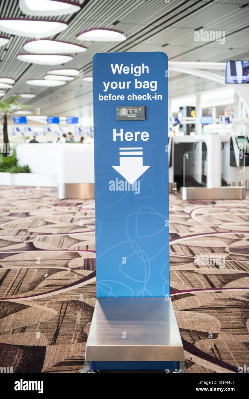Weighing scale machine at Singapore Changi Airport Terminal 4 Stock