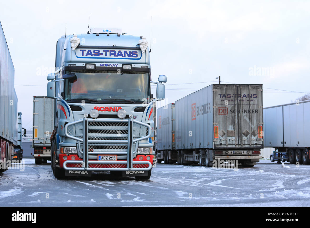 FORSSA, FINLAND - DECEMBER 20, 2014: Fleet of Scania trucks on an icy yard. Demand for heavy trucks is increasing while the need for medium-duty haula Stock Photo