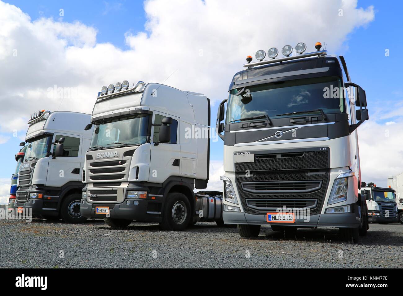 FORSSA, FINLAND - MAY 2, 2014: Row of Volvo and Scania heavy truck tractors parked. Demand for heavy trucks is increasing while the need for medium-du Stock Photo