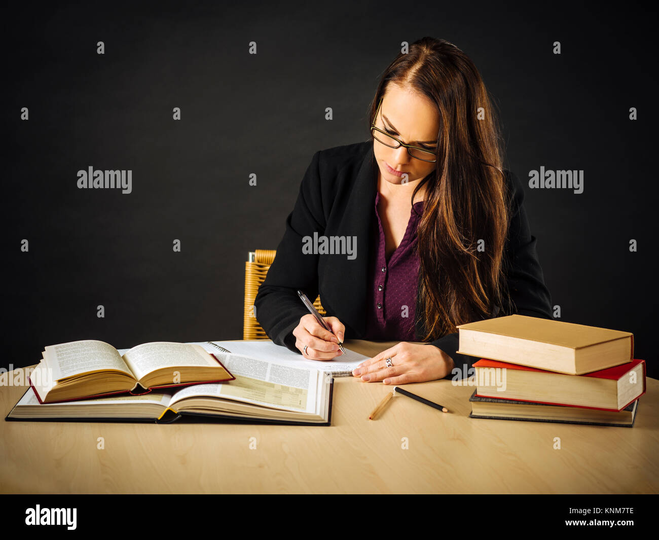 Photo of a teacher or business woman in her 30's sitting at a desk in ...