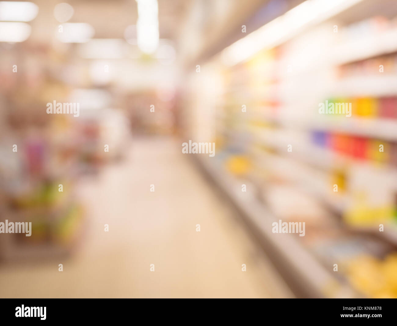 Blurred supermarket pass with colorful shelves as background. Stock Photo
