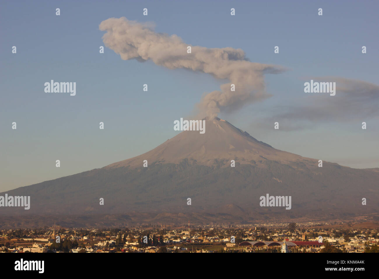 Erupting Popocatépetl, view from Cholula Pyramid, morning light, Mexico Stock Photo